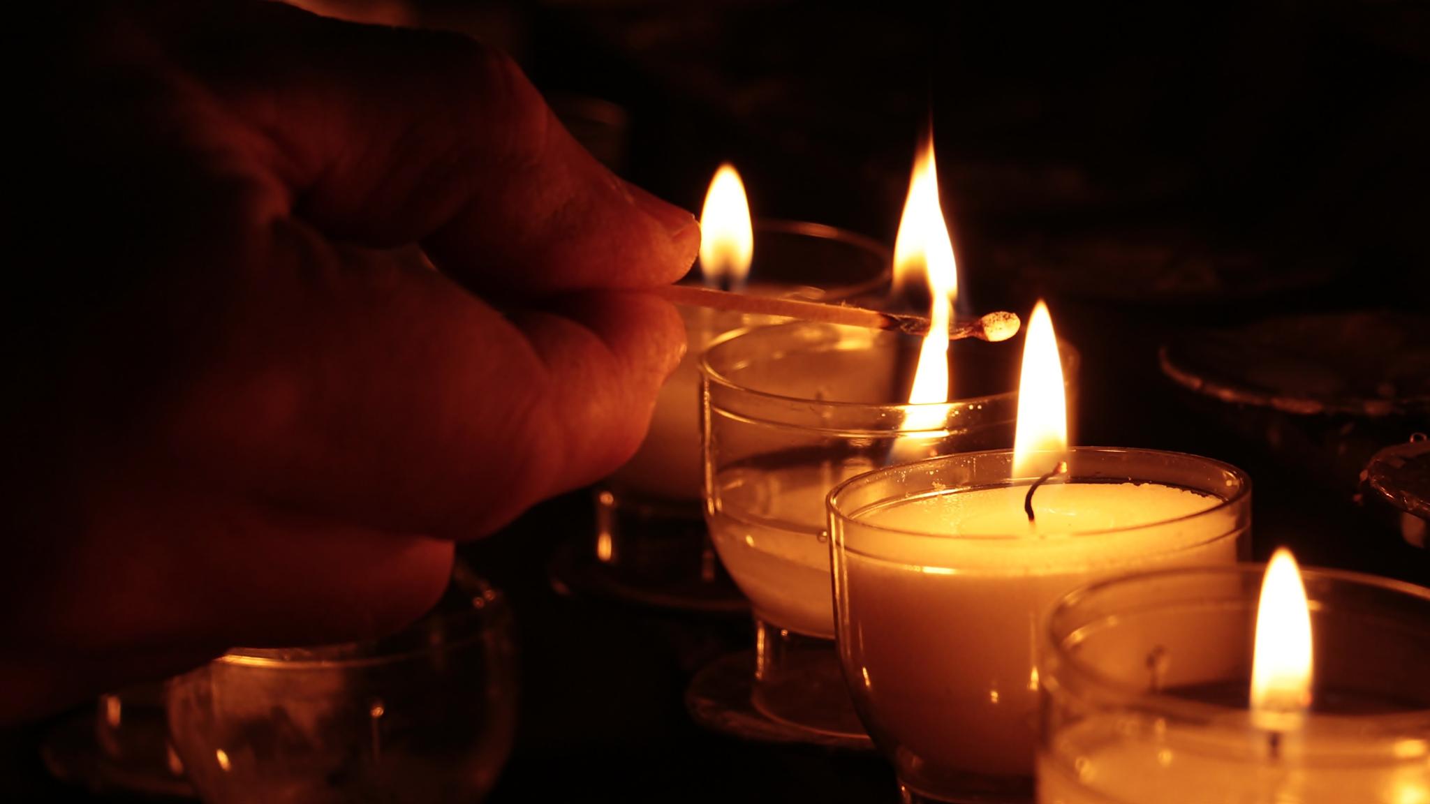 Eine Fürbitte für einen lieben Verstorbenen wird in einem Gottesdienst verlesen