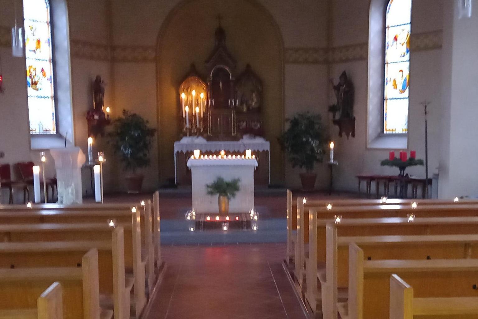 Die dunkle Kirche in Liebshausen wurde mit vielen Kerzen dekoriert
